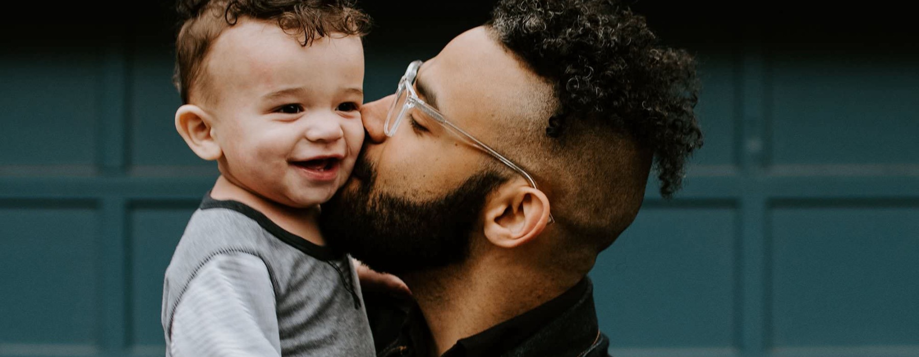 a man kissing his son